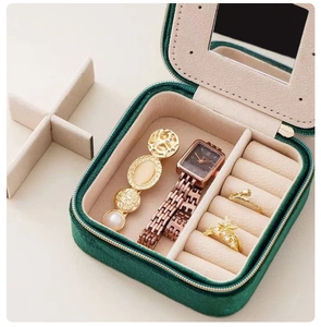 Detail view of emerald green velvet jewelry box with mirror and multi-grid storage