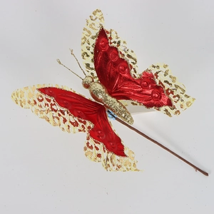 Close-up of red hollow fabric butterfly with gold glitter for Christmas decor