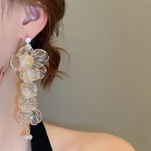 Floral tassel drop earrings featuring acrylic petals and sparkling rhinestone accents