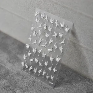 Detailed macro view of 5D white embossed crane nail stickers with item code to 2308