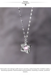 Macro detail of silver star pendant with heart-shaped pink zircon on gray fabric