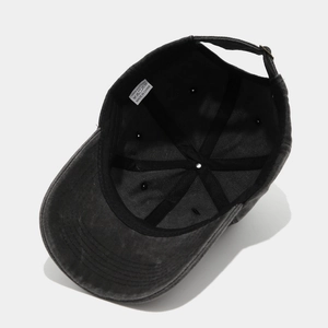 Internal view of a washed grey cotton baseball cap with six-panel structure and metal buckle