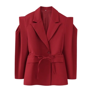 Détail du blazer rouge avec découpes aux épaules et ceinture réglable pour souligner la taille