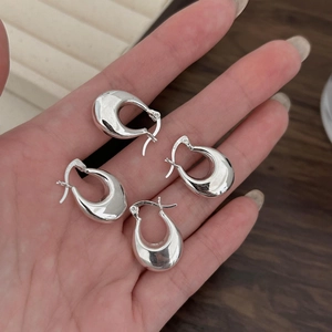 Detail of silver S925 sterling silver U-shaped hoop earrings with mirror polished finish
