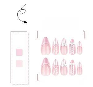 Detail of pink almond nails featuring 3D bows, pearls and lace ribbons on glossy polish