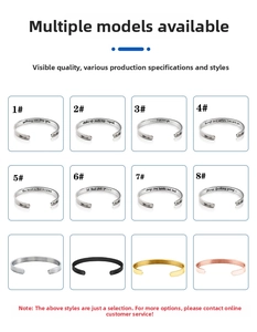 Detailed view of stainless steel C-shaped bracelets in silver, gold, and black with engravings