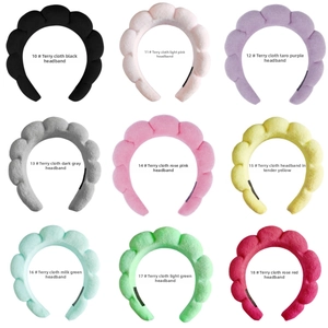 Macro shot of nine multi-colored padded sponge headbands showing various fabric textures