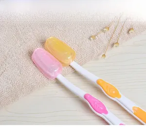 Detail of pink and yellow translucent toothbrush head covers with snap closure