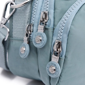 Light blue nylon crossbody bag with multiple zip compartments and BOBO logo hardware
