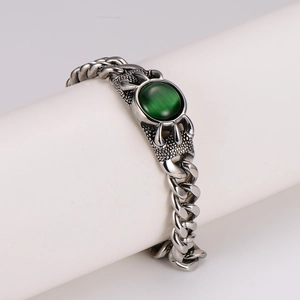 Punk style silver Cuban chain bracelet with green agate stone on a display stand