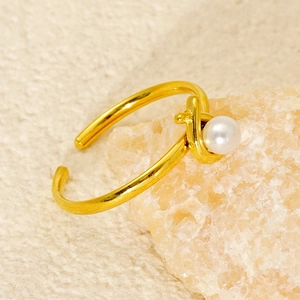 Dettaglio ravvicinato di un anello di perle placcato oro su base in pietra naturale