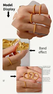 Detail view of stackable gold beaded rings with a minimalist polished metal sphere design
