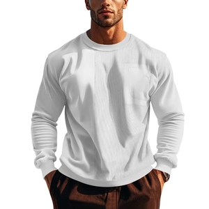 Detail of white crewneck sweatshirt with corduroy paneling and front pocket texture