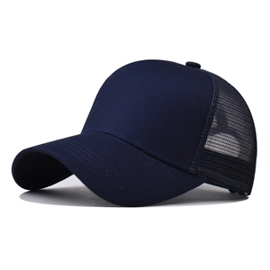 Close-up side view of navy blue breathable mesh and cotton fabric on trucker hat