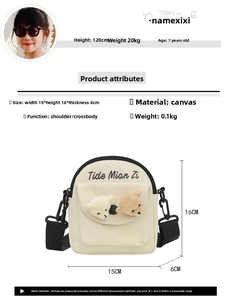 Detail view of mini cream canvas crossbody bag featuring 3D plush bear charms