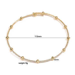 Minimalist gold adjustable choker necklace with cubic zirconia beads on white background