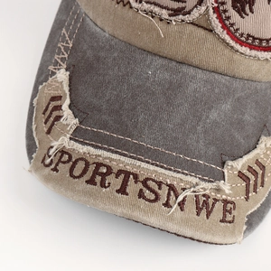 Macro detail of distressed washed cotton baseball cap with embroidered sports patch