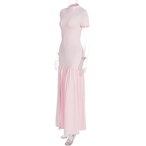 Detail of pink summer dress featuring side slit with elegant ruffled hem and high neck design