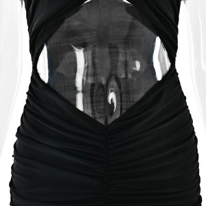 Detailed close-up of black ruched evening dress with sexy waist cutout design on mannequin