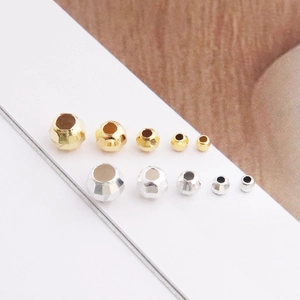 Close-up of faceted S925 sterling silver beads in gold and silver for DIY jewelry