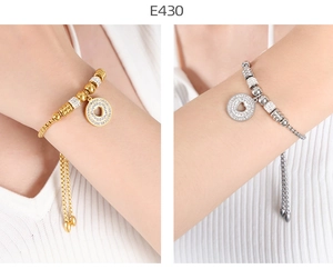 Detail of adjustable heart bracelets in gold and silver with cubic zirconia inlays