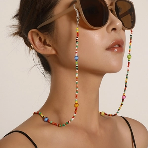 Colorful acrylic bead eyewear chain for women shown worn by model on a beige background