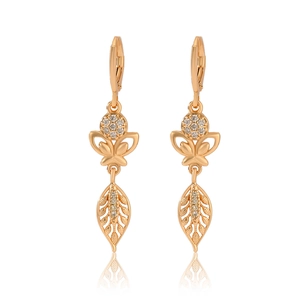 Macro shot of gold leaf and butterfly earrings with sparkling cubic zirconia stones