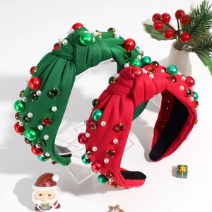 Christmas knotted headband with green and red pearls and colorful rhinestones on white background