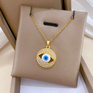 Close-up of golden Evil Eye necklace with sparkling cubic zirconia in a jewelry box