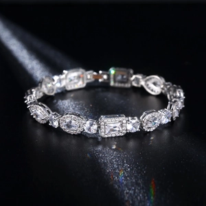 Macro shot of silver plated bracelet with mixed-cut zirconia stones on dark background
