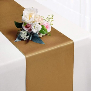 Golden satin table runner with silky texture and fine stitching for wedding decor