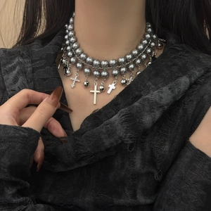 Detailed view of layered gunmetal grey pearl choker with metallic gothic crosses