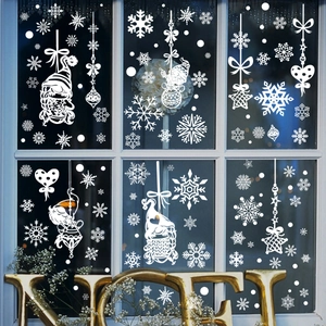 White Christmas window decals with gnomes and snowflakes on a six-pane glass window