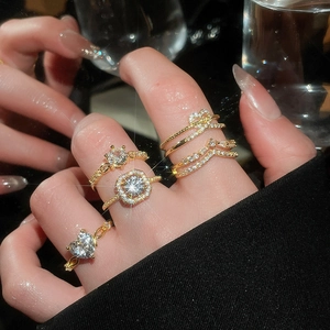 Close-up of five-piece gold heart zircon ring set worn on a hand with luxury aesthetic