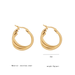 Macro view of triple-layered C-shape golden stainless steel earrings with 2cm diameter size
