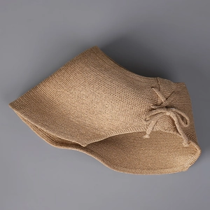 Detail of khaki paper knit sun hat featuring a delicate bow and fine woven texture