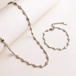 Polished stainless steel four-leaf clover necklace and bracelet set in silver finish