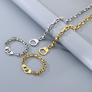 Detail of gold and silver handcuff-style chain necklaces and bracelets in steel