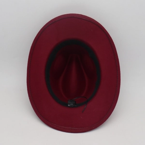 Detail of burgundy fedora hat interior with 100% polyester label and sweatband