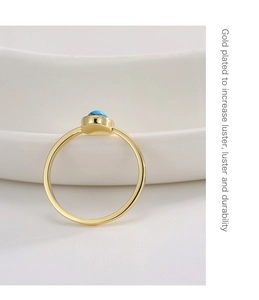 Detail of gold plated ring with turquoise stone showing luster and durability