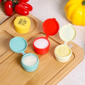 Set of four colorful cartoon plastic sauce containers on a rustic wooden tray
