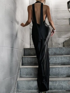 Detailed back view of a black satin halter dress with an open back and floor-length hem
