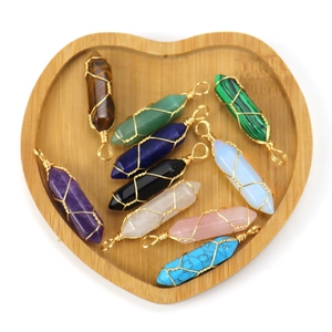 Handmade wire wrapped natural crystal hexagonal point pendants in a heart wooden tray
