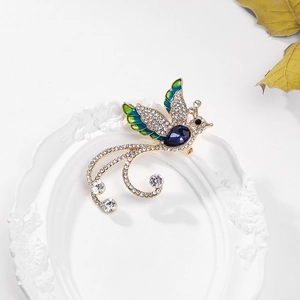 Detailed macro view of an elegant phoenix brooch with blue enamel and sparkling crystals