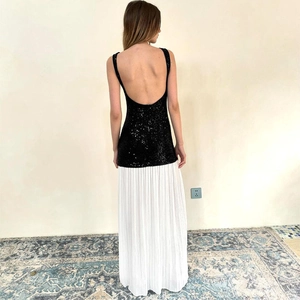 Detailed back view of backless sequined patchwork maxi dress with white pleated skirt