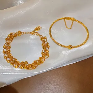 24K gold plated geometric bead bracelets set on white silk background with matte finish