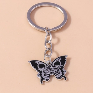 Macro detail of gothic butterfly skull pendant with black enamel finish on a silver keyring