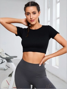 Detail of laser-cut hollow pattern and ribbed texture on black yoga crop top sleeves