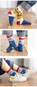 Detailed view of mid-calf cotton socks with cute patterns and flexible elastic cuffs