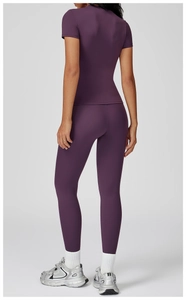 Detail of slim fit dark purple brushed yoga set showing matte stretch fabric texture
